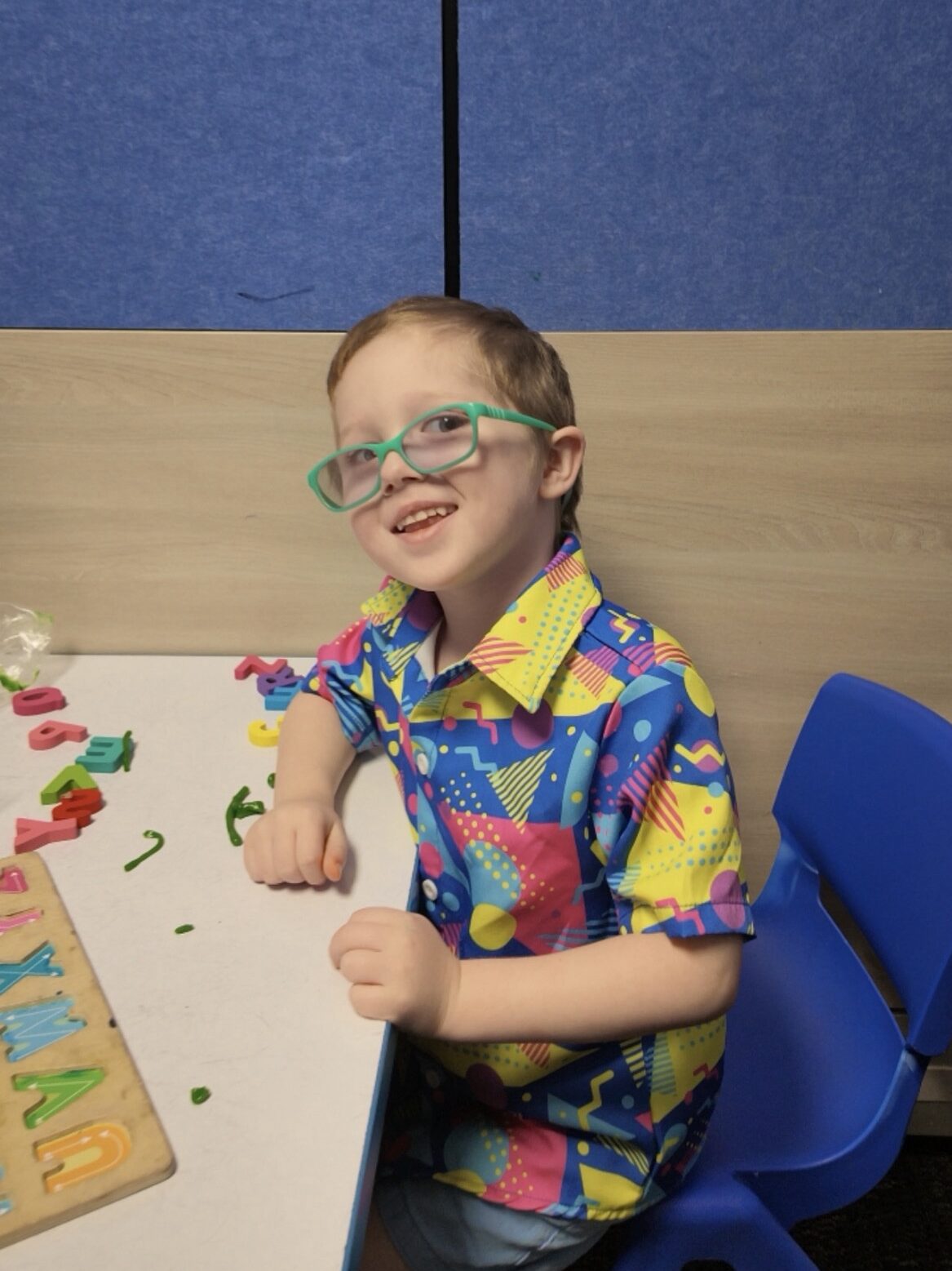 Kiddo with blue glasses smiling